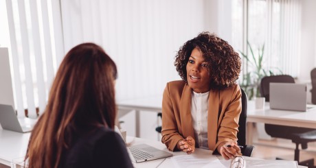 A car insurance agent explains policy. | The Benefits of Working with a Car Insurance Agent